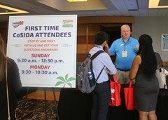 At-Large Representative Bill Dyer of Virginia Tech visits with first time CoSIDA attendees.